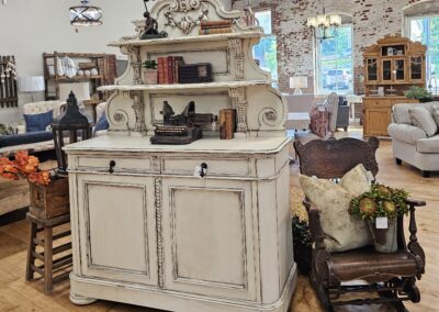 Antique white hutch in a cozy furniture showroom