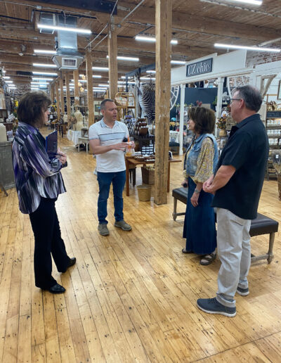 People talking inside a rustic wooden interior store.