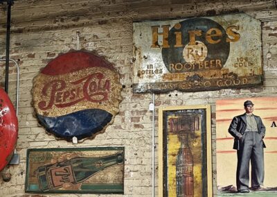 Vintage beverage metal signs on brick wall