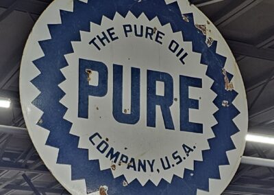 Vintage Pure Oil Company sign with logo hanging