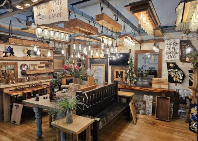 Rustic cabin interior decor store with varied wooden furniture.