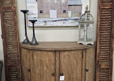 Vintage wooden door with wall art above.