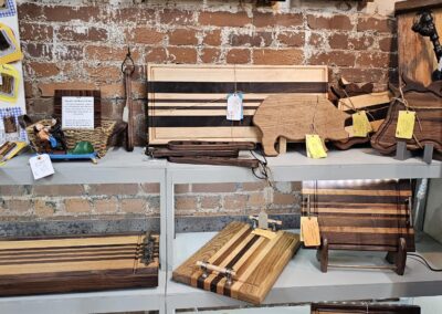 Various wooden cutting boards displayed on a wall.