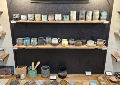 Handcrafted pottery display at Copper Tree Pottery store.